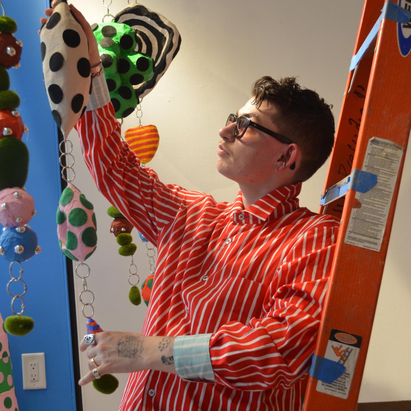 Zander Schlacter hanging his art on the window.