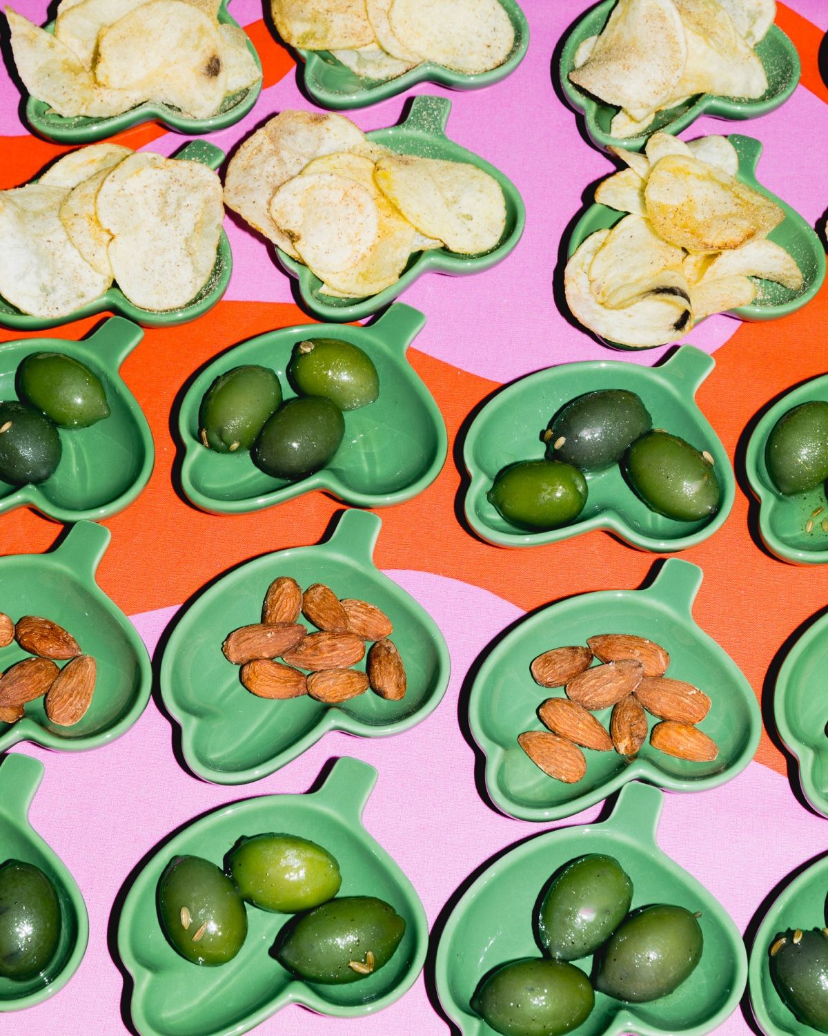 Bowls of olives, nuts and chips.