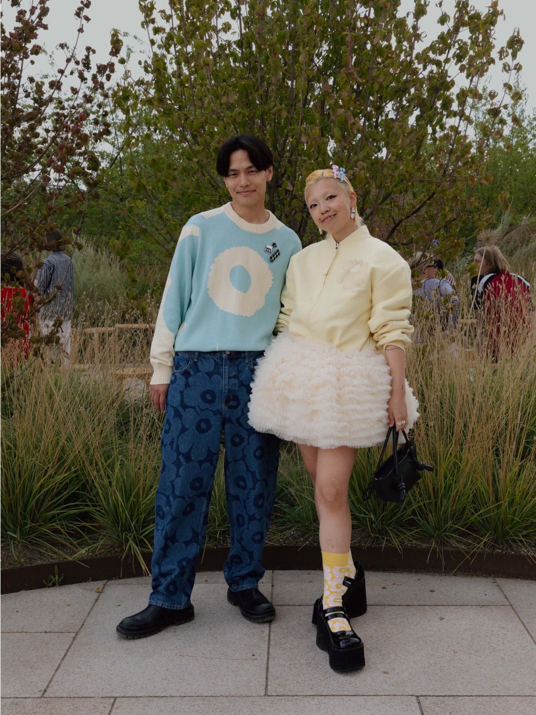 Hiroki Tabata and Fumina Tsuji wearing blue Maridenim jeans, blue-white knit with Unikko pattern and light yellow jacket with Unikko.