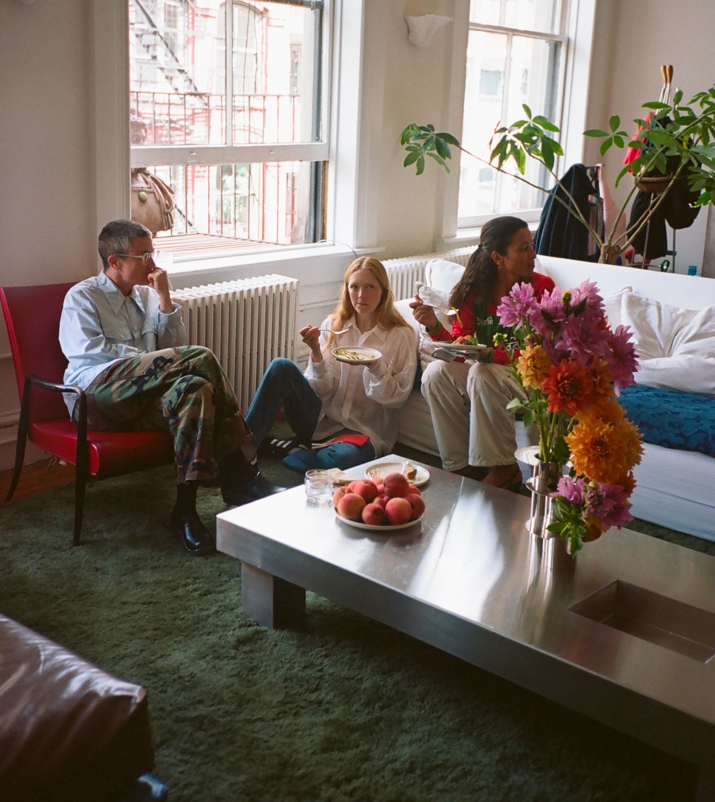 Guests enjoying lunch in Laila Gohar's living room