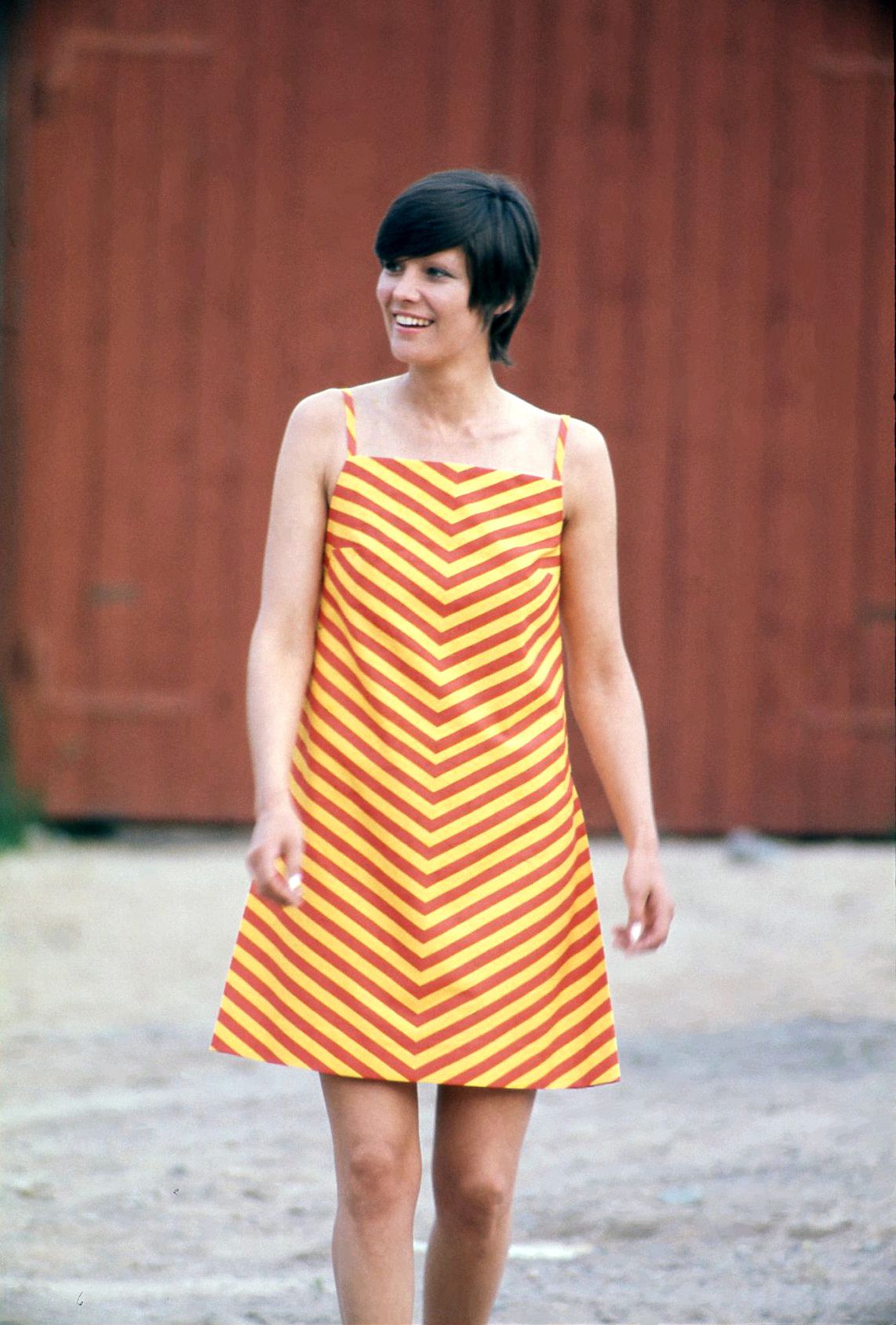 Smiling model wearing vintage Marimekko Marimini dress outdoors. 