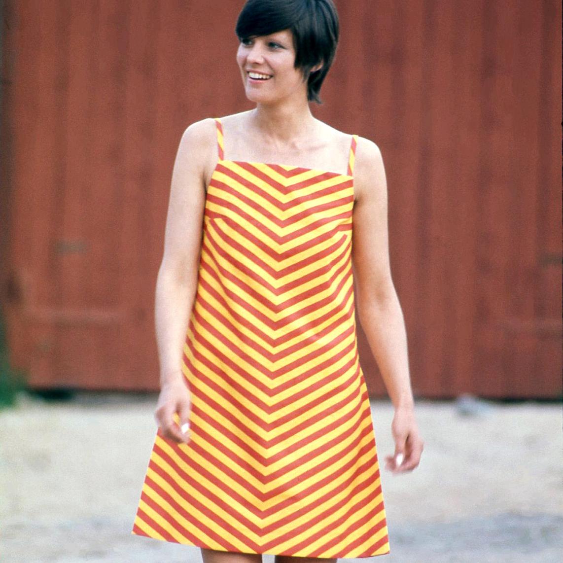 Smiling model wearing vintage Marimekko Marimini dress outdoors.