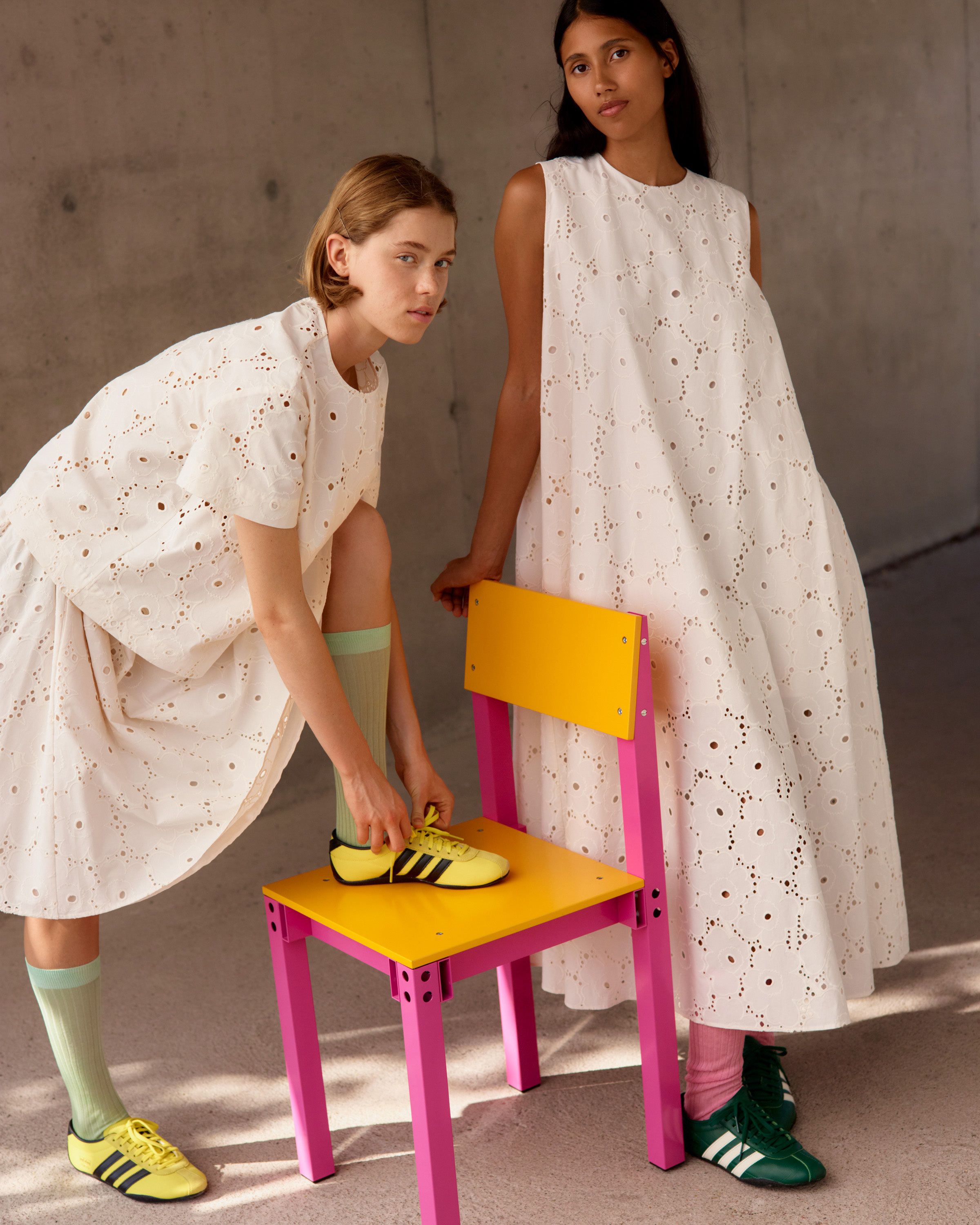 Two models wearing Alustus shirt, Sommittelu skirt and Alvariinsa dress in embroidered Unikko print.