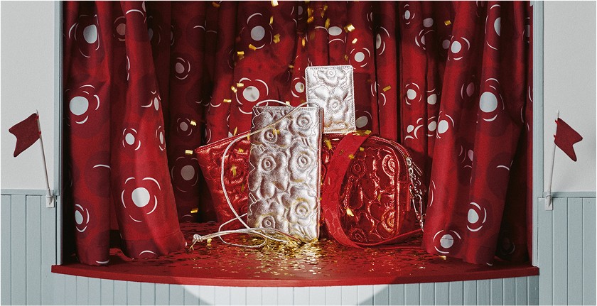 Red and silver Gratha bag stacked, displayed on stage.