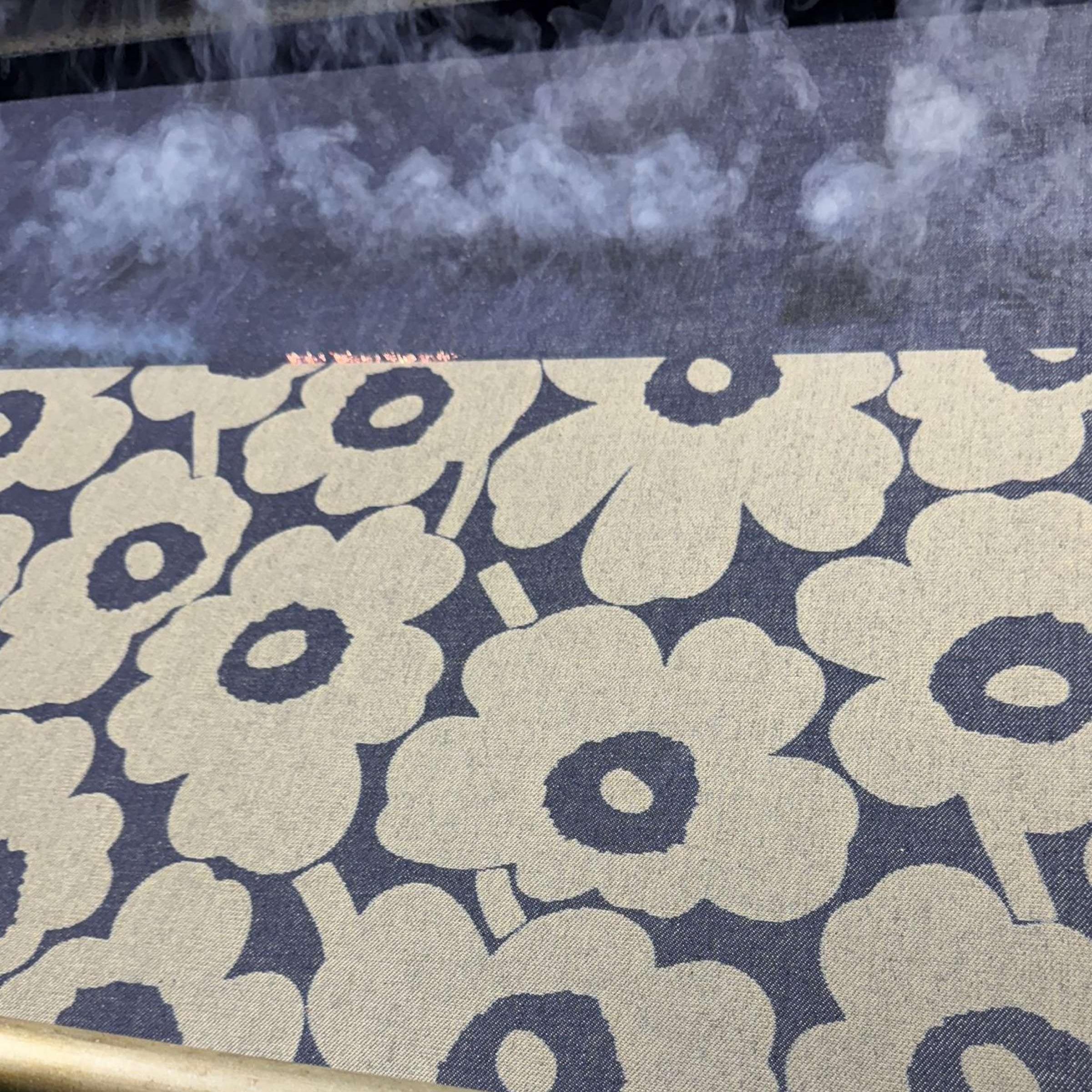 The surface of the denim fabric is lasered with a Unikko pattern