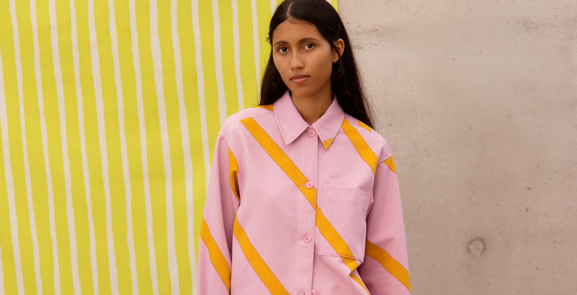 Model wearing a shirt and shorts in light pink Basso print.