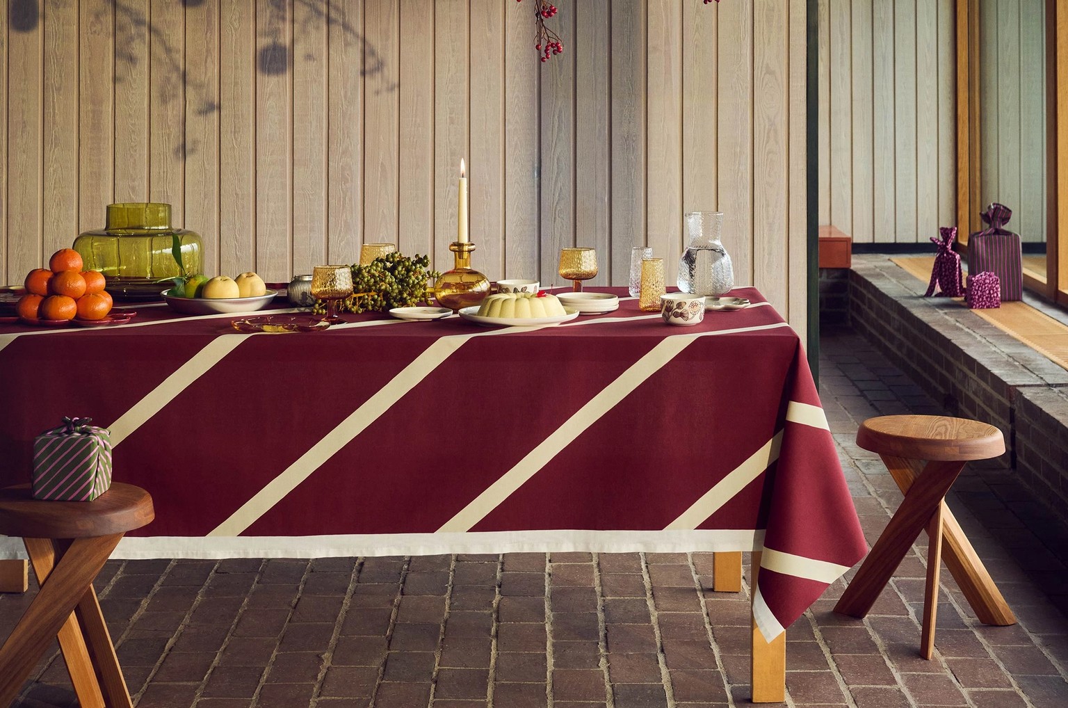 Holiday tablesetting with ornaments hanging above the table.