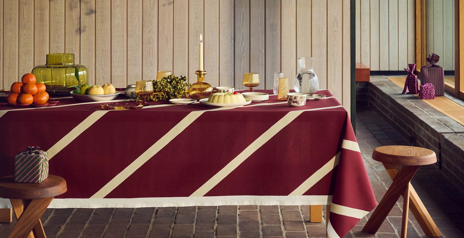 Holiday tablesetting with ornaments hanging above the table.