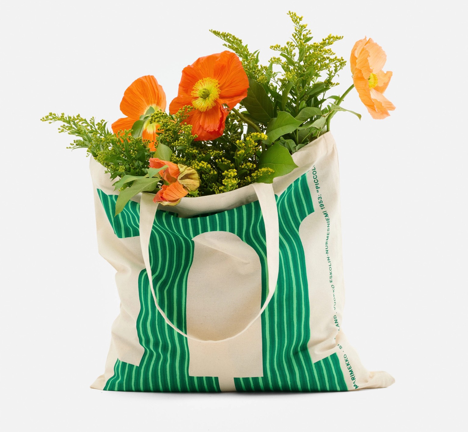 Logo tote, with a green letter M in Piccolo print, filled with flowers.