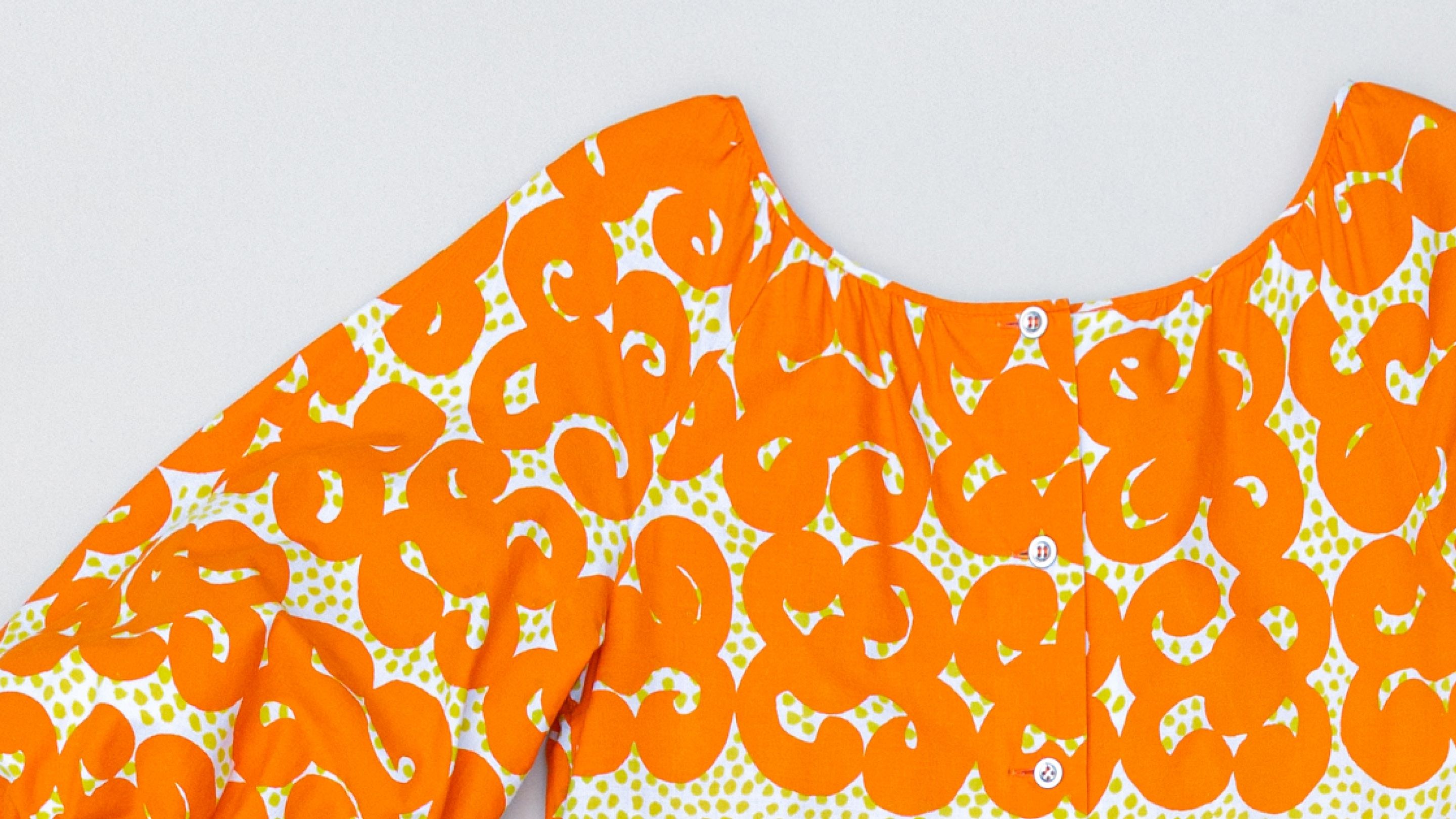 Vintage dress with orange Jokeri print.