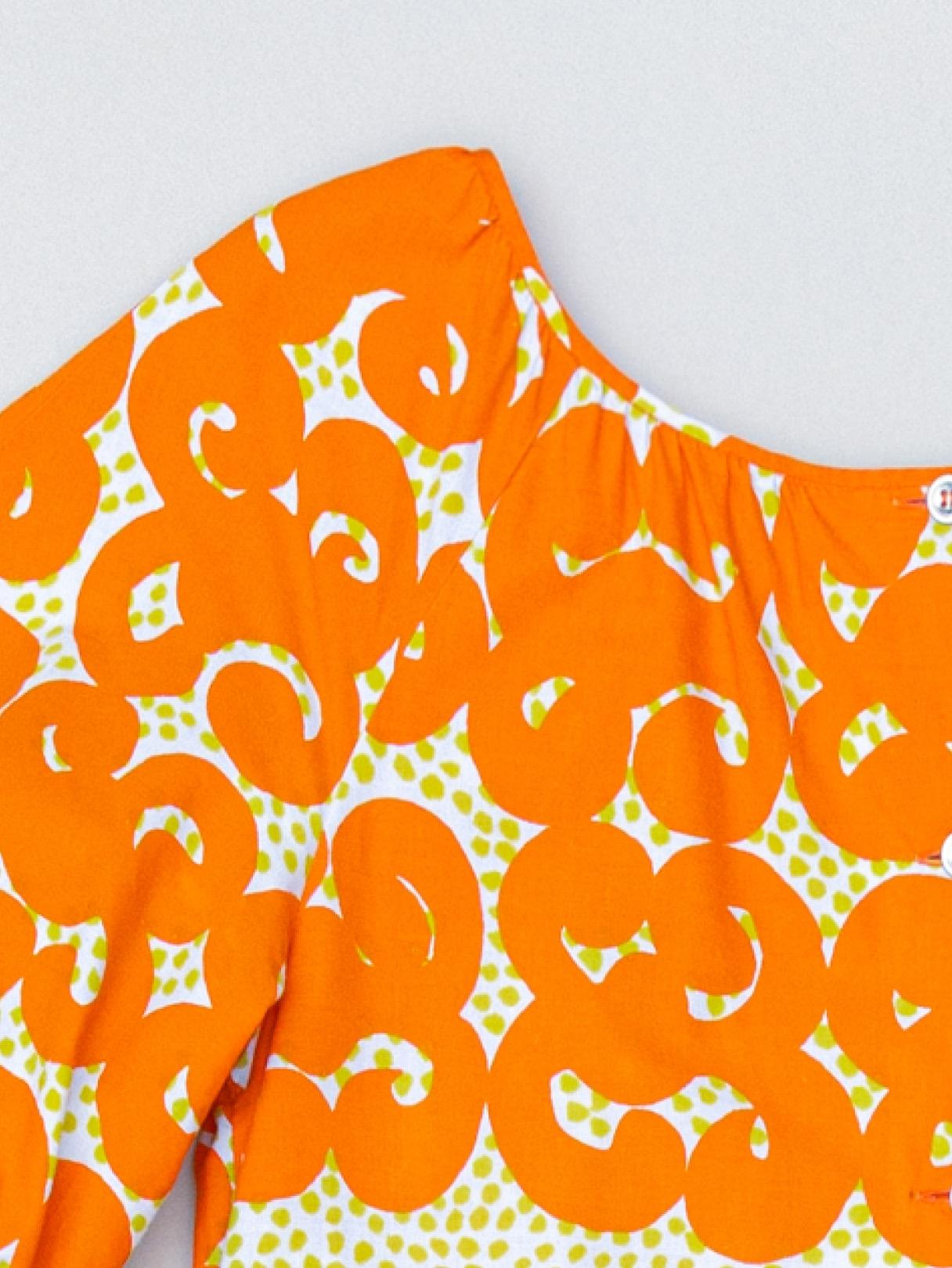 Vintage dress with orange Jokeri print.