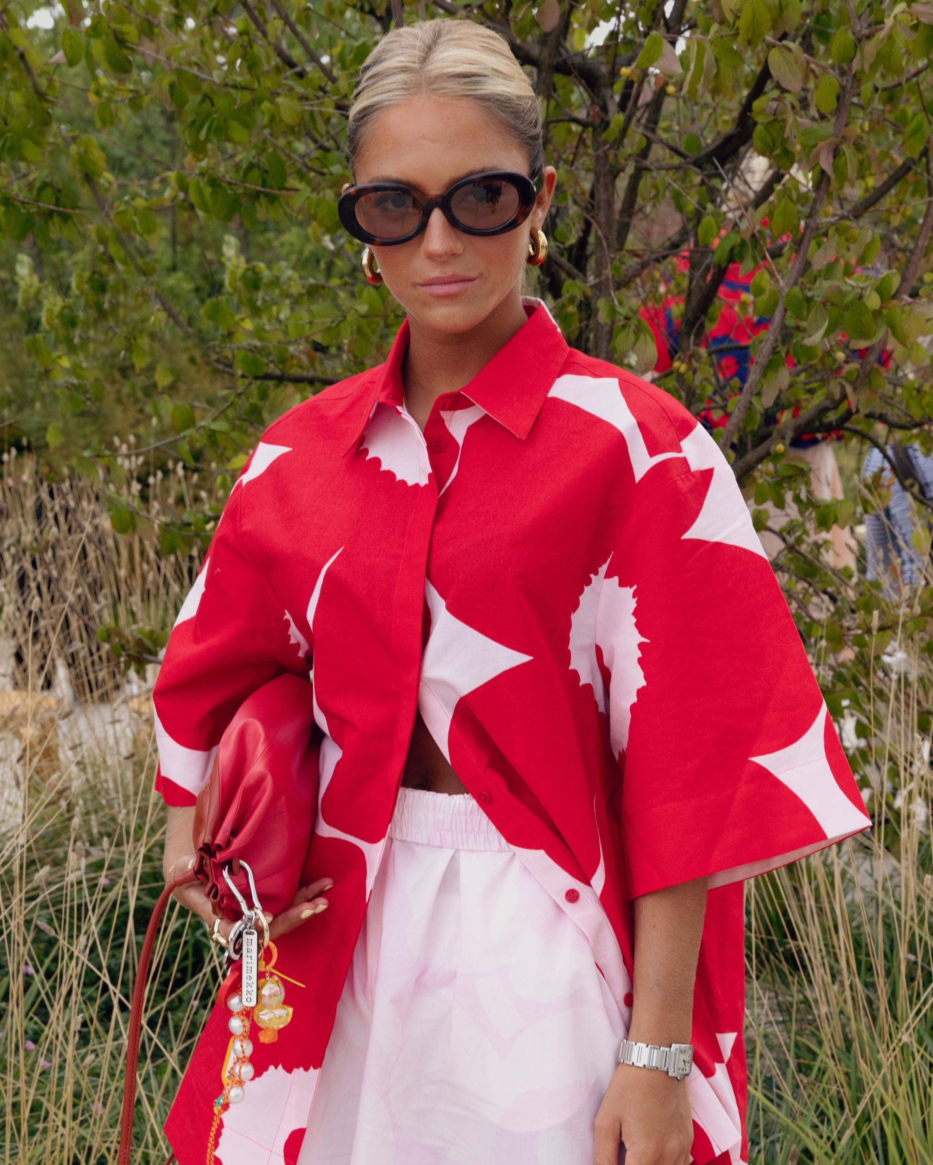 Caetana Afonson wearing pink-red shirt with Unikko-print