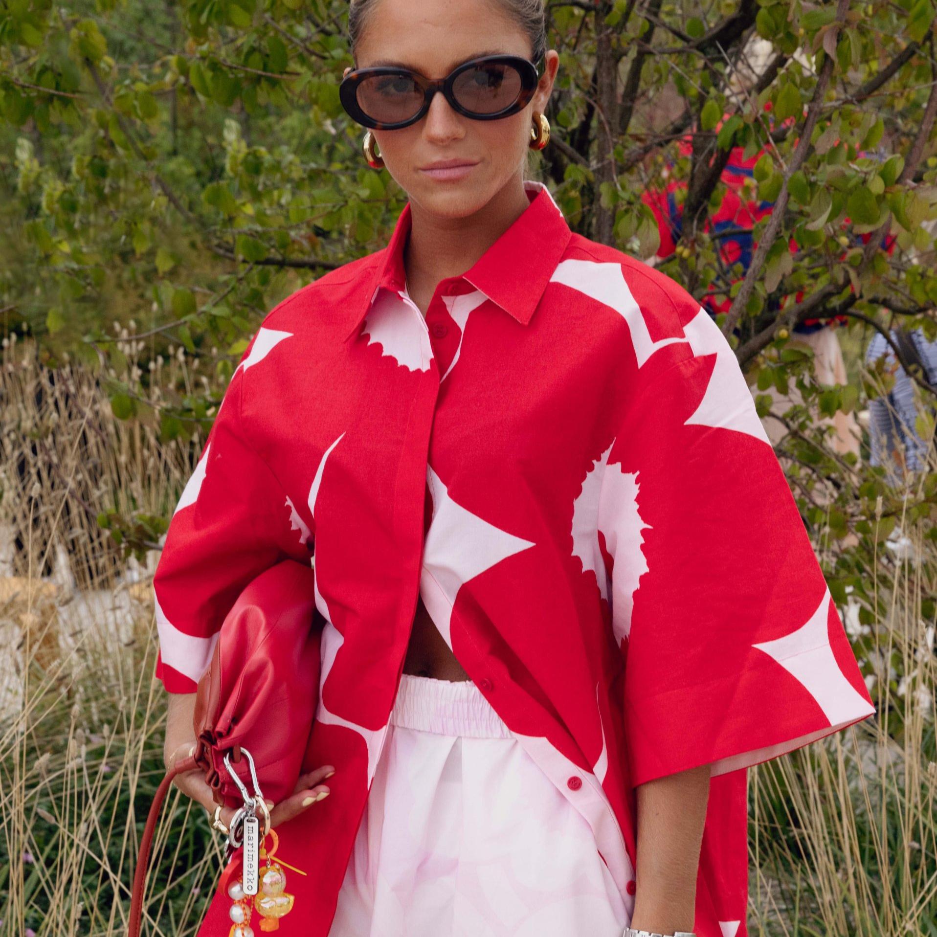 Caetana Afonson wearing pink-red shirt with Unikko-print