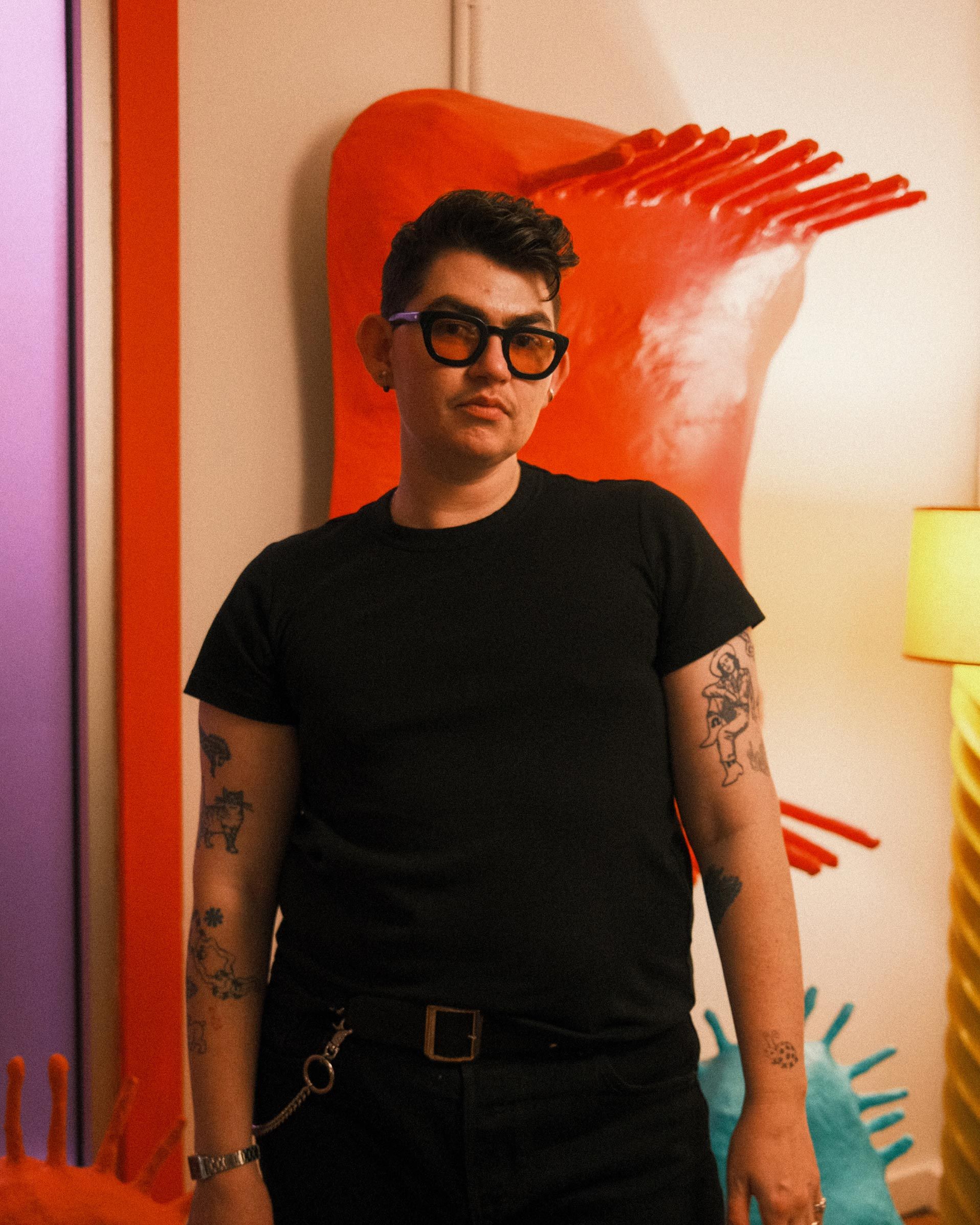 Artist and designer Zander Schlacter in a black t-shirt.