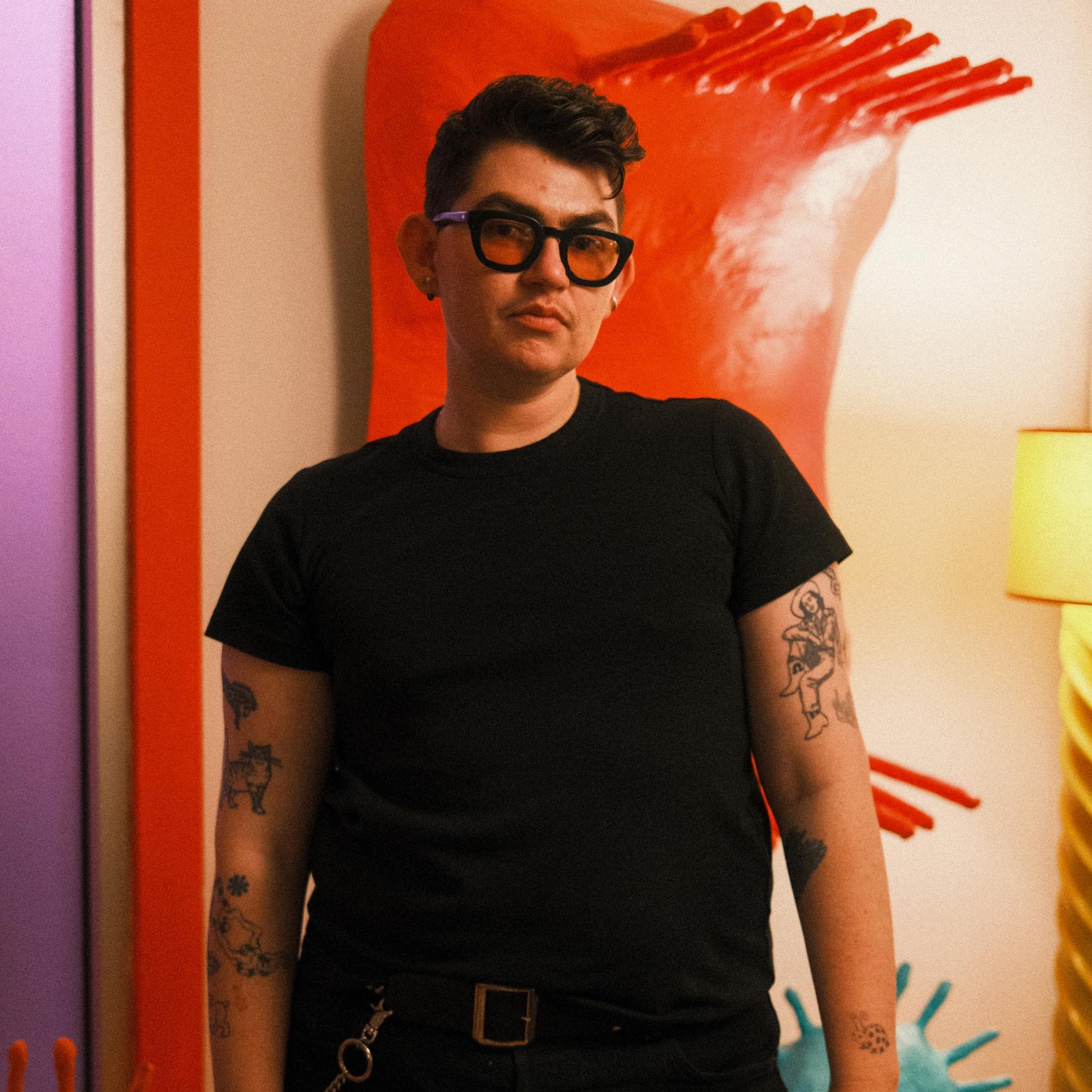 Artist and designer Zander Schlacter in a black t-shirt.