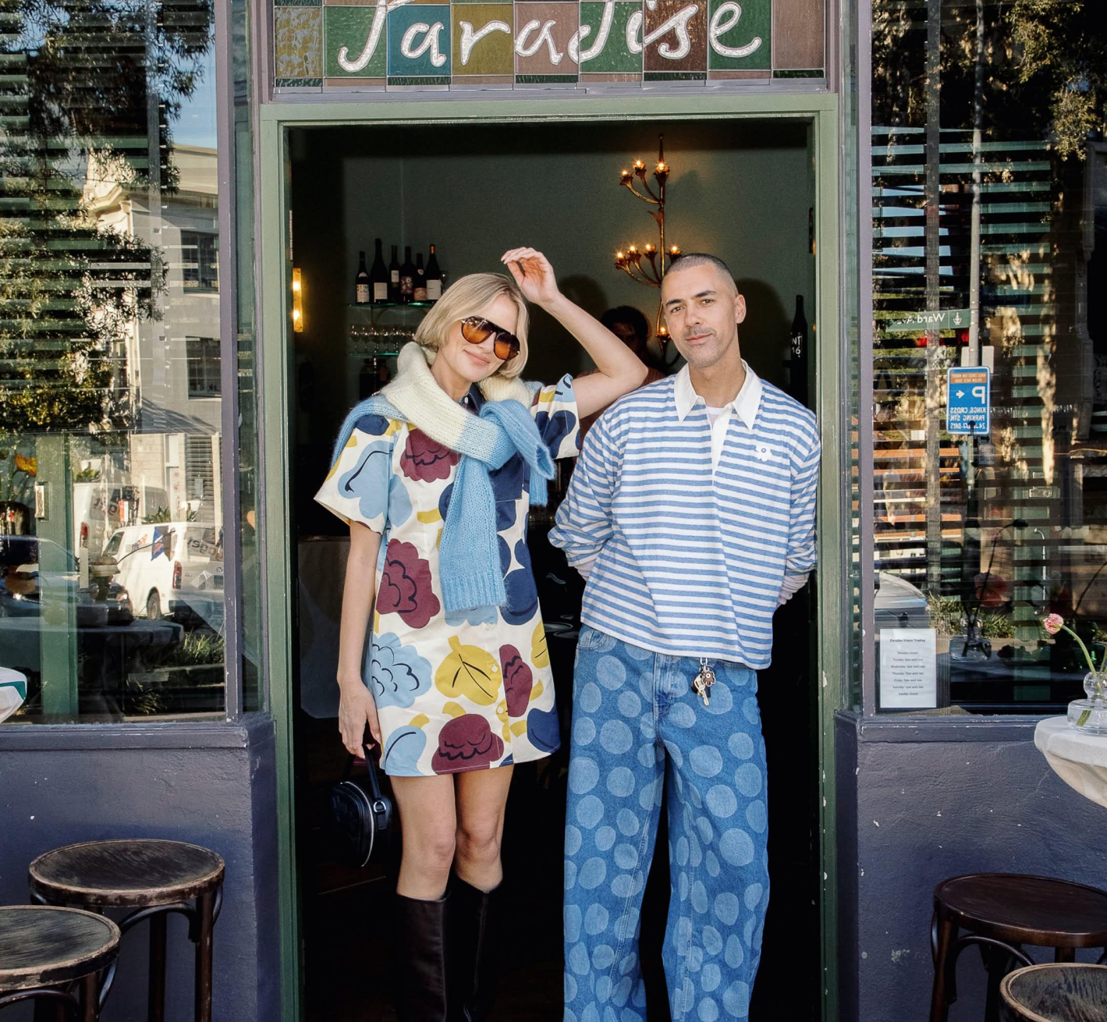 @mrturner wearing Kioski jersery top in blue and white stripe and @violetgrace wearing Seikkailu Kukasta Kukkaan dress in shades of blue burgundy and yellow white blue and yellow knit draped over shoulders