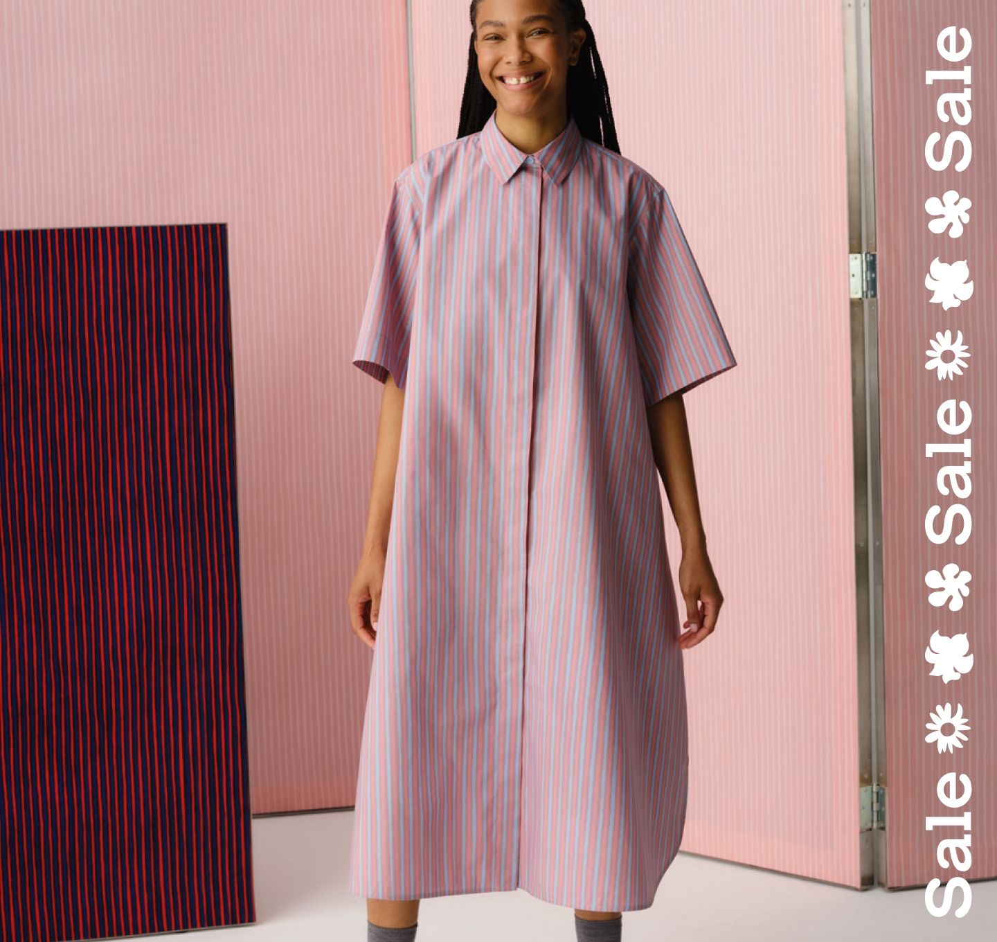 Model wearing a dress in Piccolo print and sale text stripe vertically on the right.