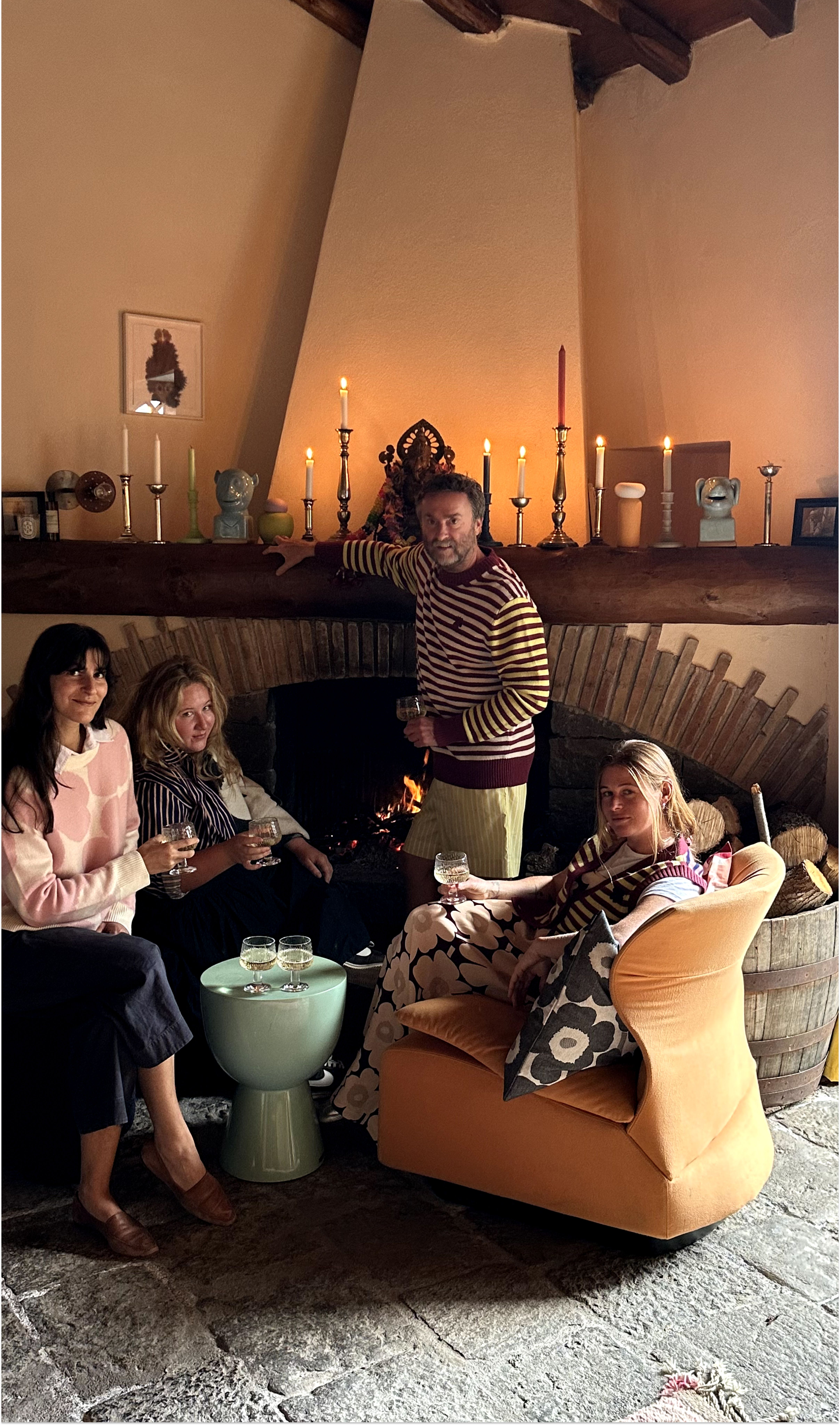 Lukas Lewandowski standing next to fireplace with his friends