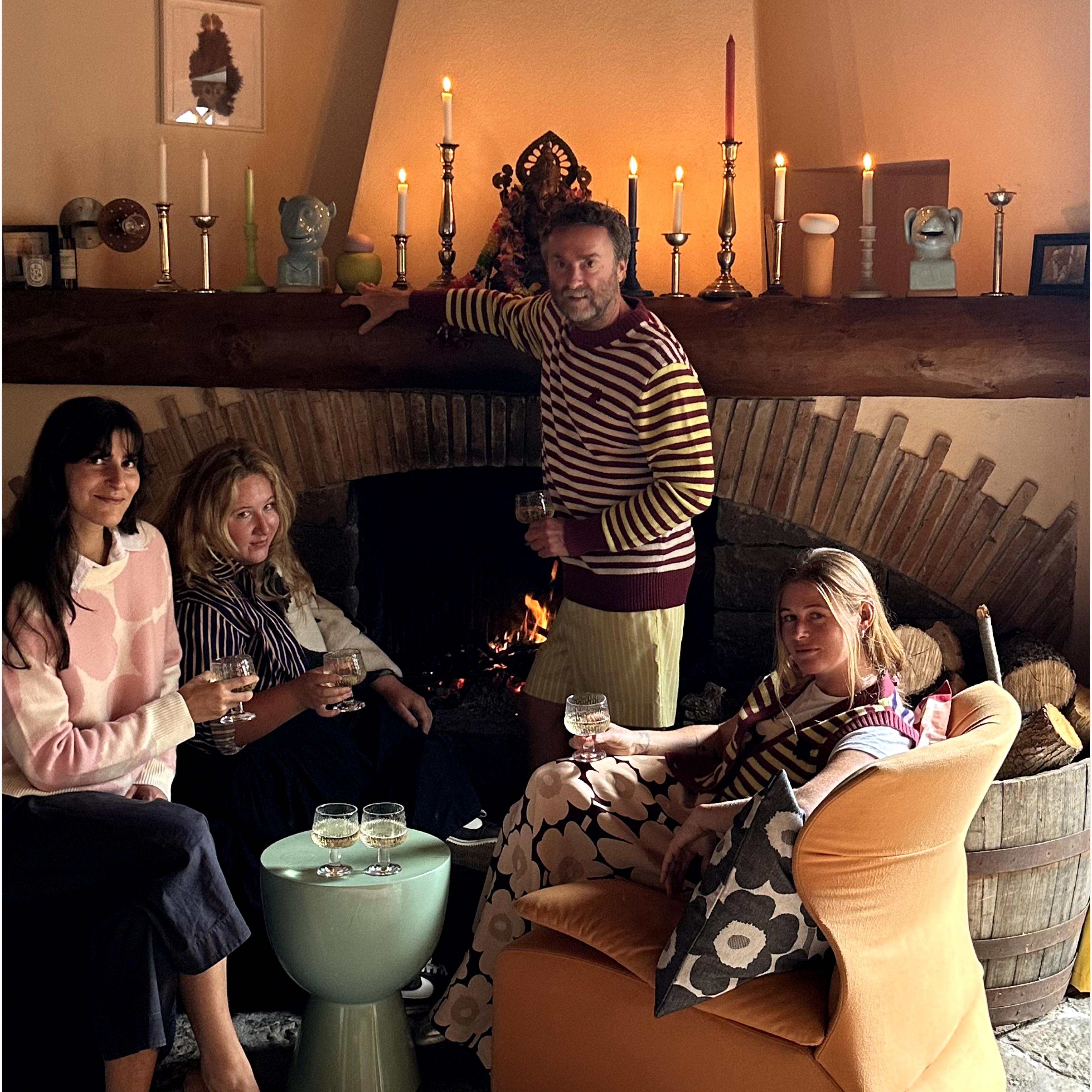 Lukas Lewandowski standing next to fireplace with his friends