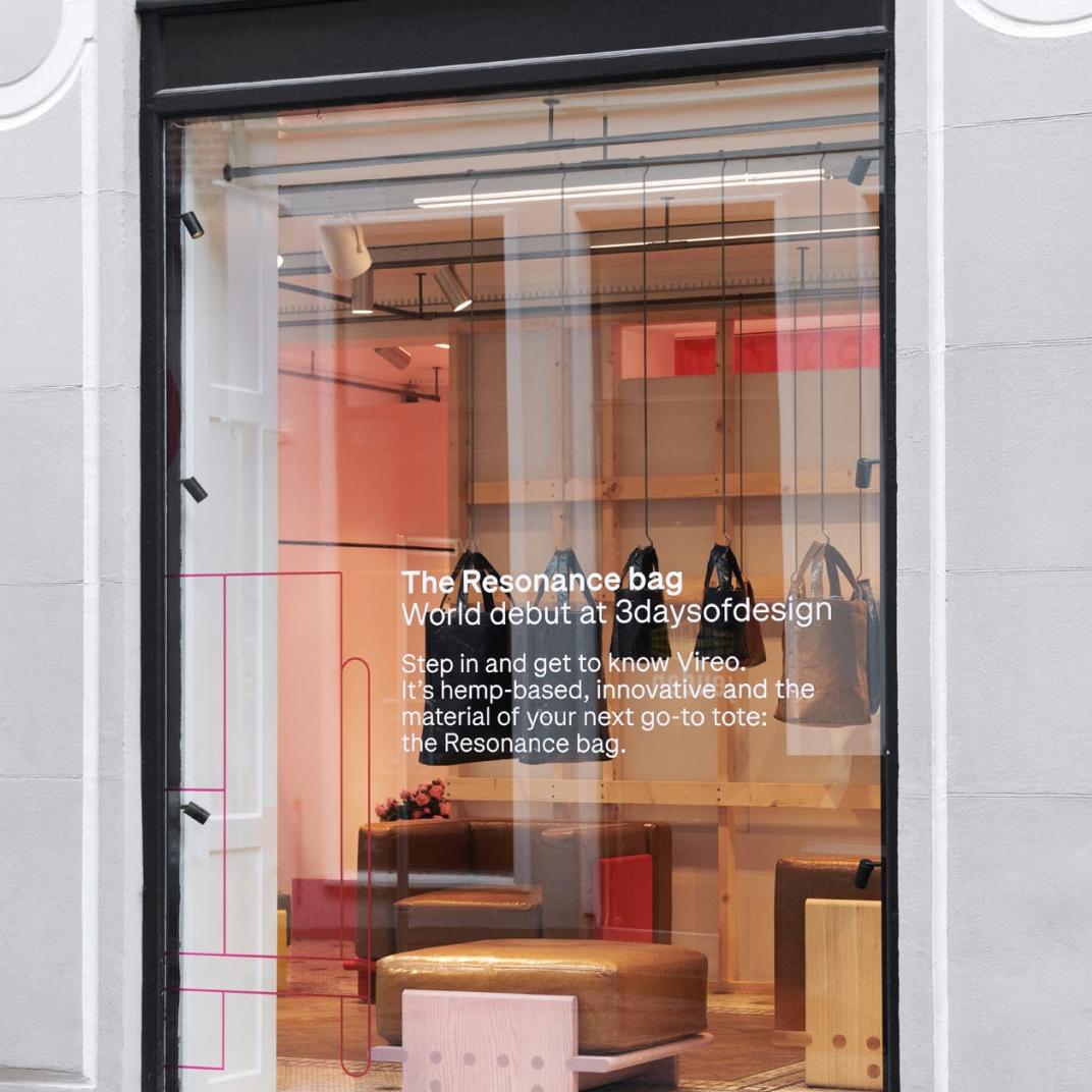 Window of a store in Copenhagen, with text about the Vireo material of the Resonance bag collection.