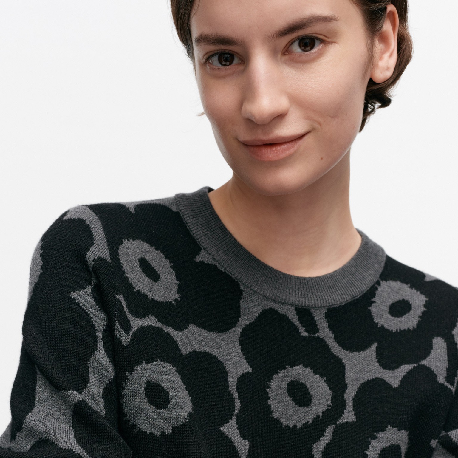 Model wearing wool knit in Unikko pattern.