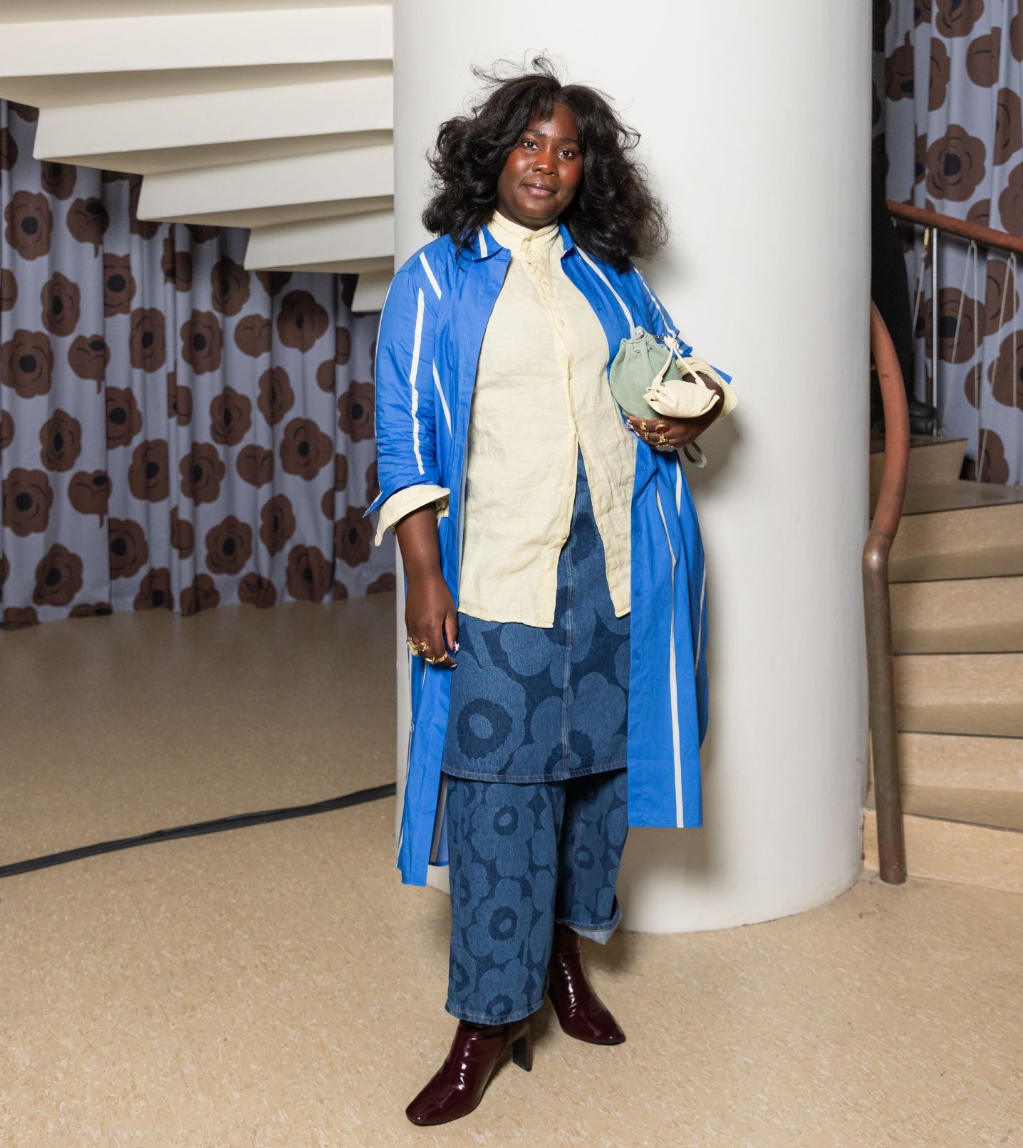 Luena Gama wearing blue and white outfit consisting of Maridenim trousers and skirt.