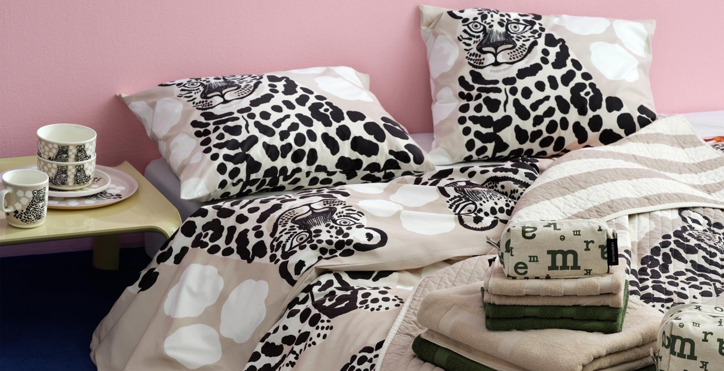 Beige Kaksoset bedding placed on a bed.