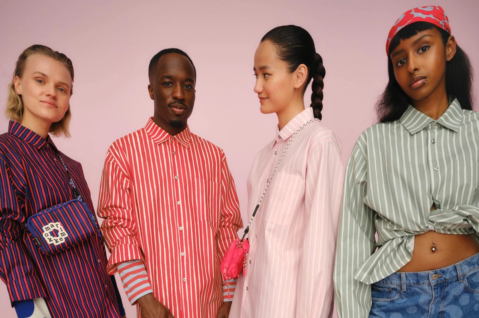 Four models wearing Marimekko Jokapoika shirts in joyful colors.