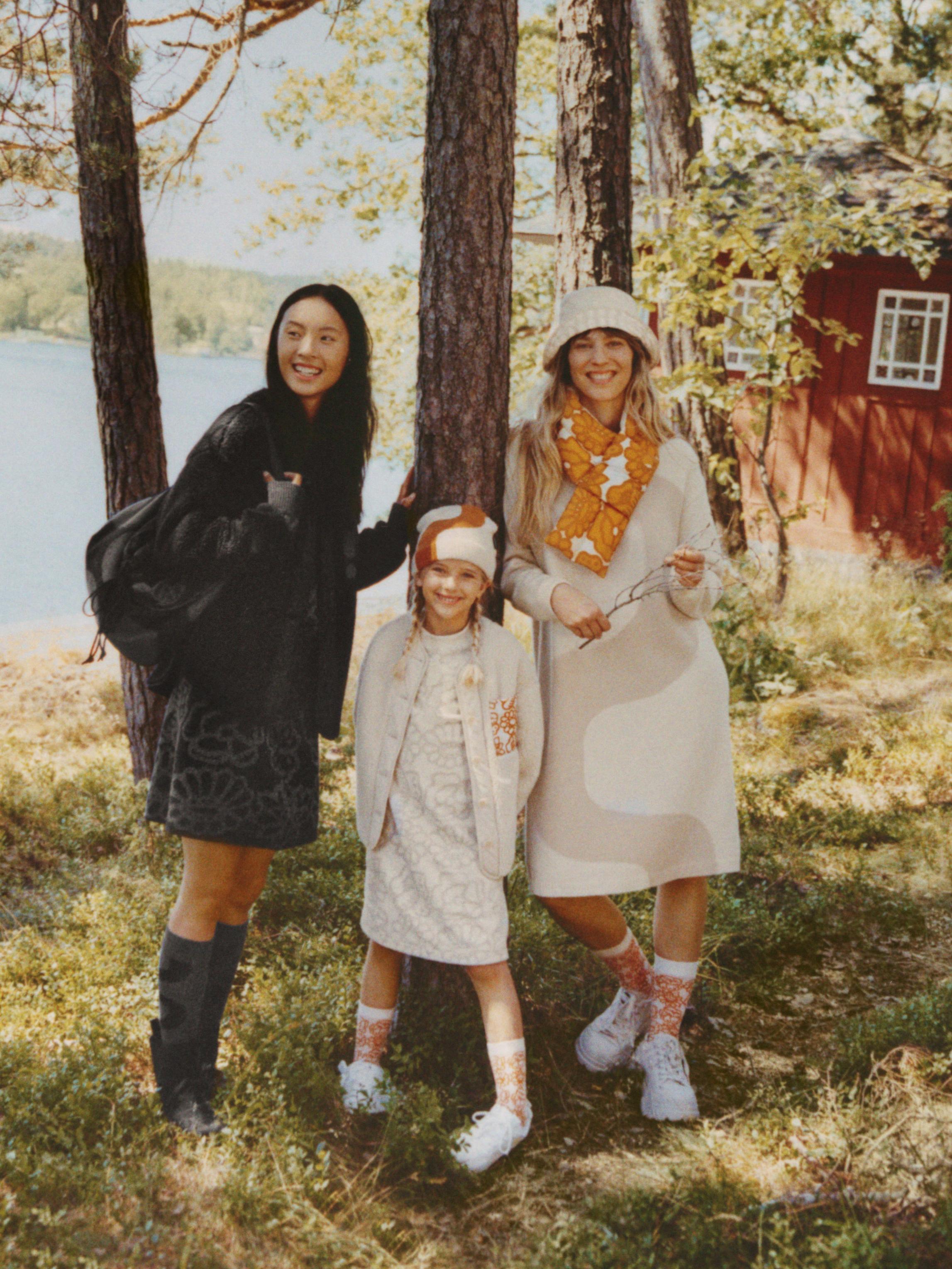 Models wearing Uniqlo x Marimekko collaboration items.