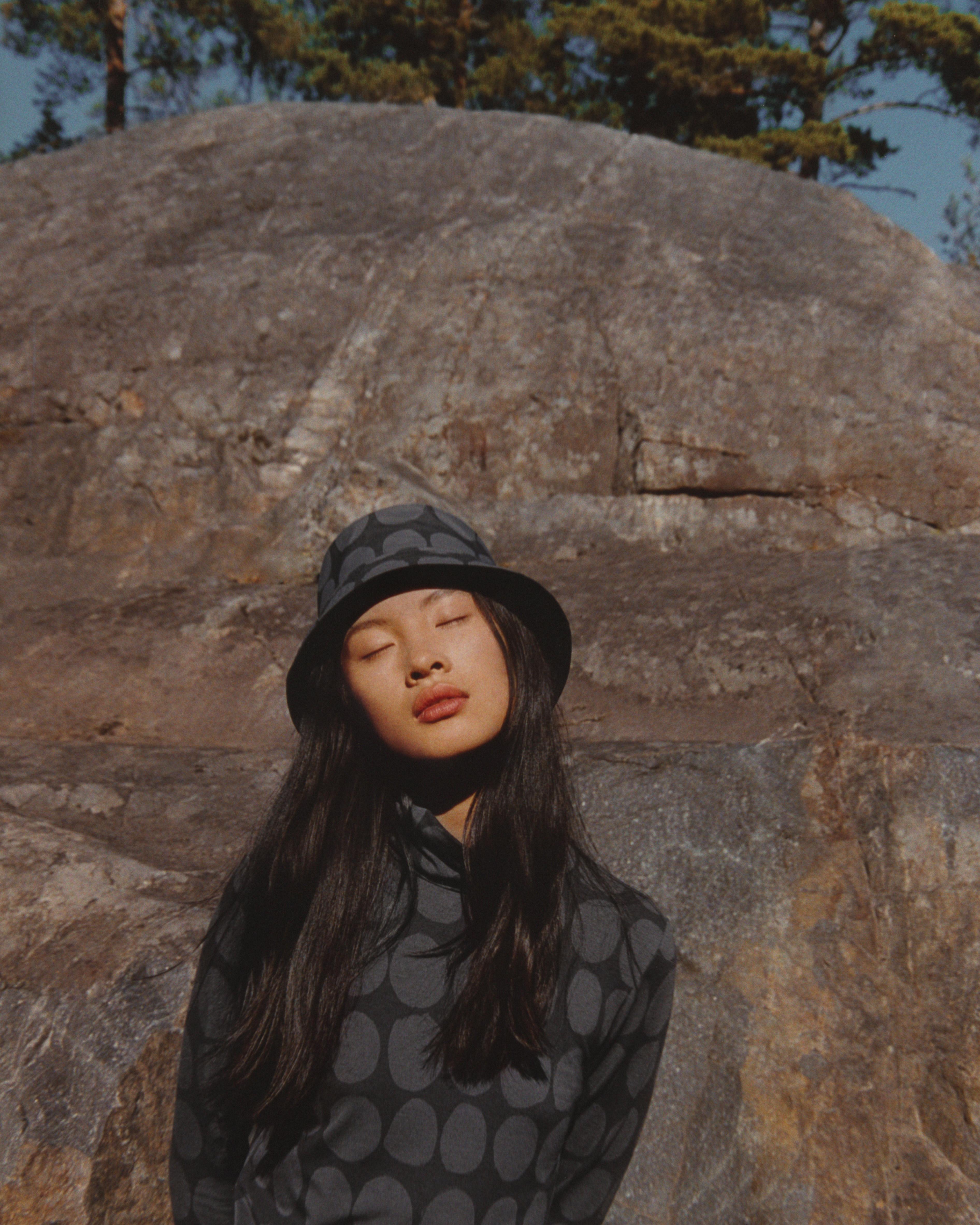 Model wearing Uniqlo and Marimekko collaboration dress and hat in Koppelo pattern