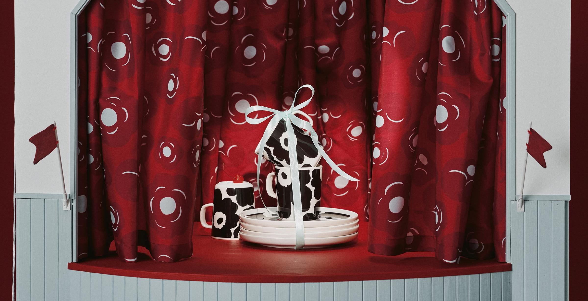 Ensemble tasse et assiette Oiva à motif Unikko noir.