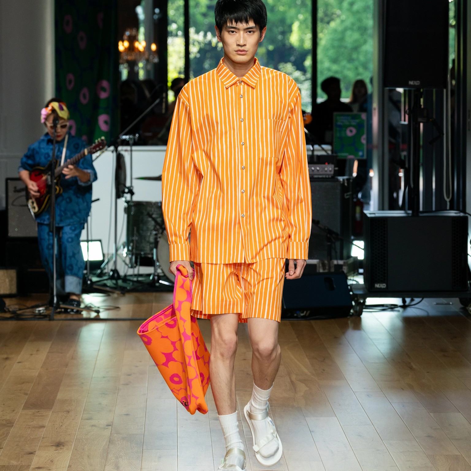 Model wearing orange Jokapoika outfit and Knitted bag.