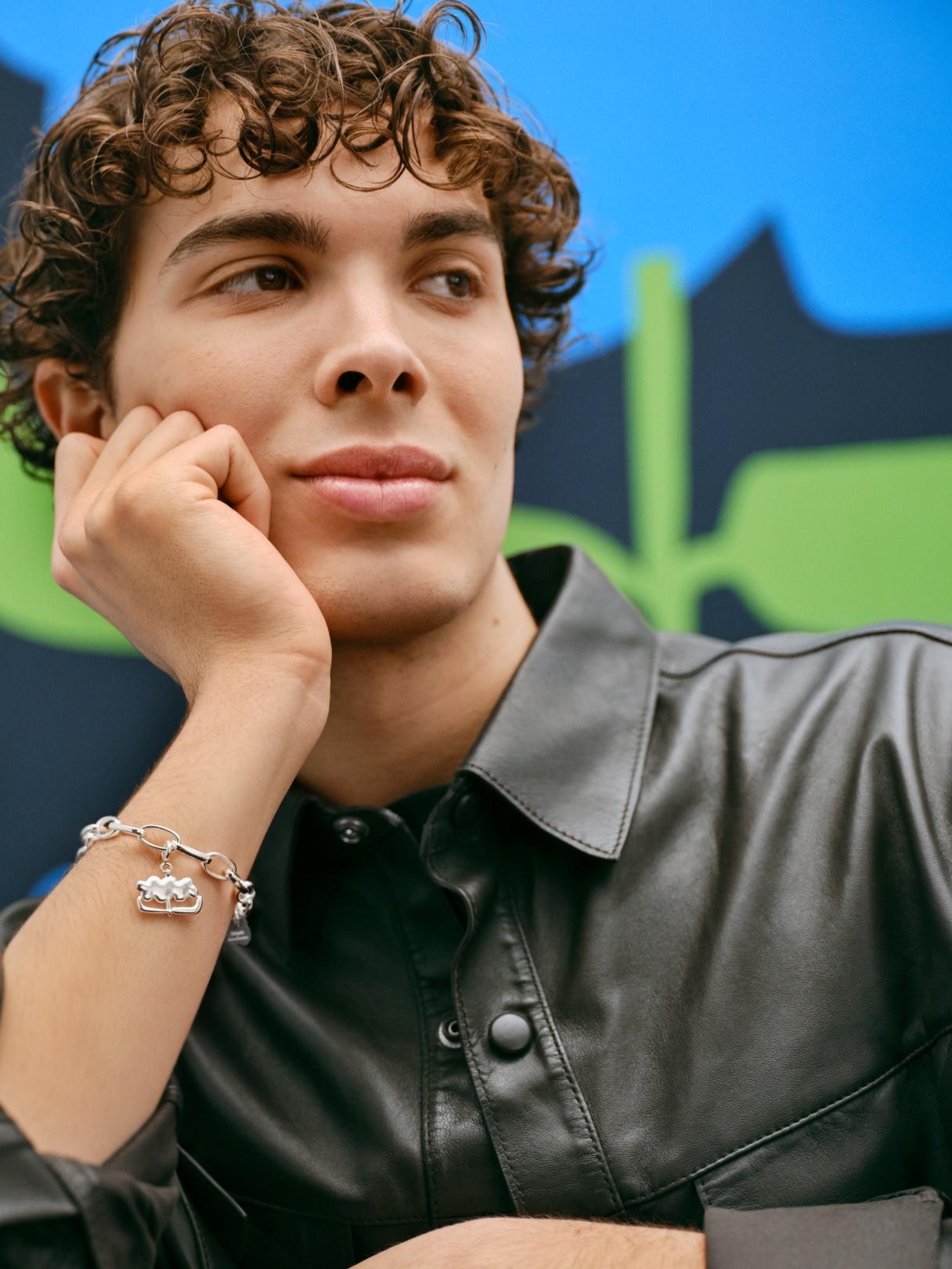 Two photos: first one has a model posing in a corner with Kalevala x Marimekko necklace and the other one has a close up of a model posing with Kalevala x Marimekko Garden bracelet.