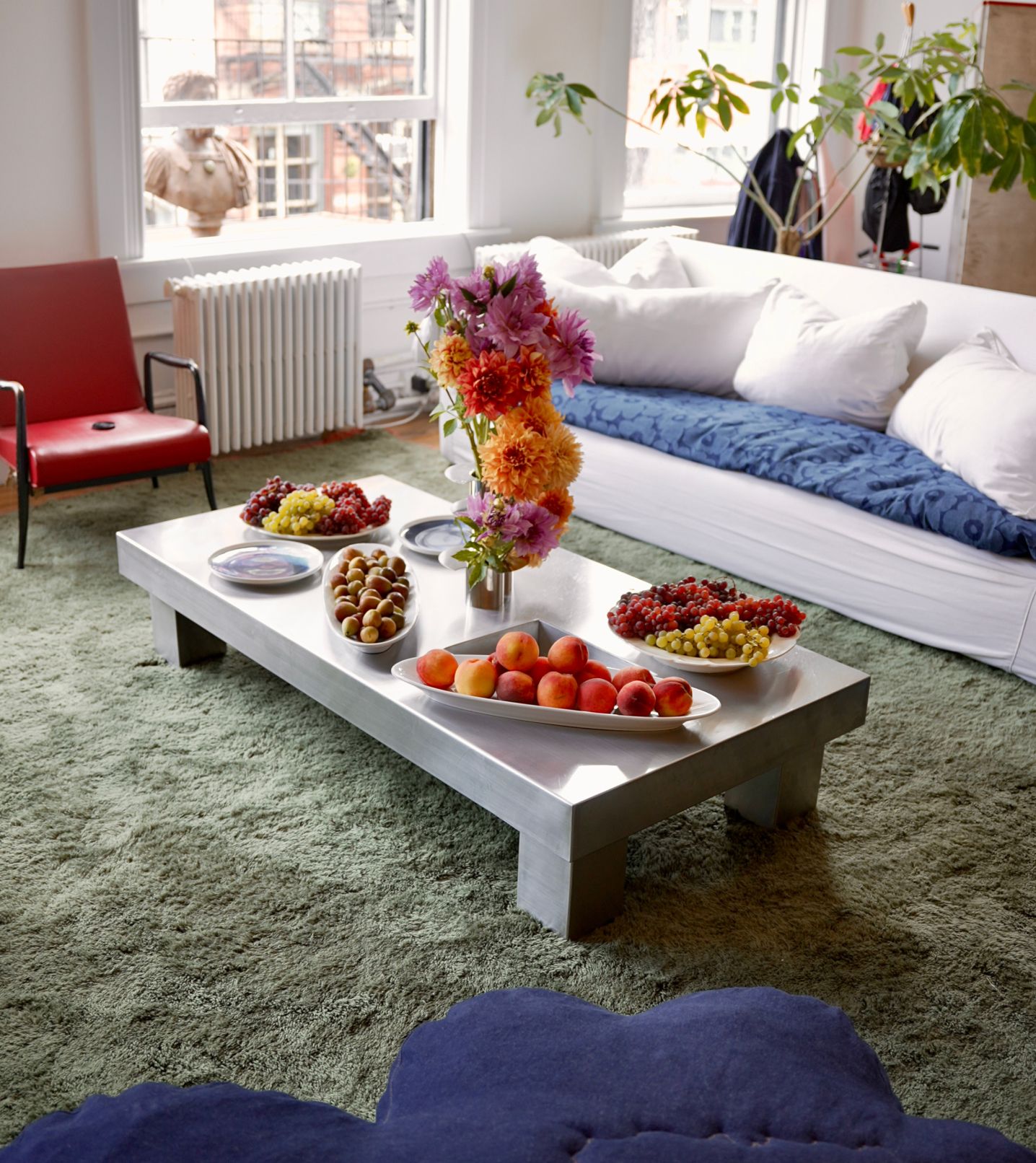 Fresh fruit on the silver table in Laila Gohar's living room, decorated with colorful flowers