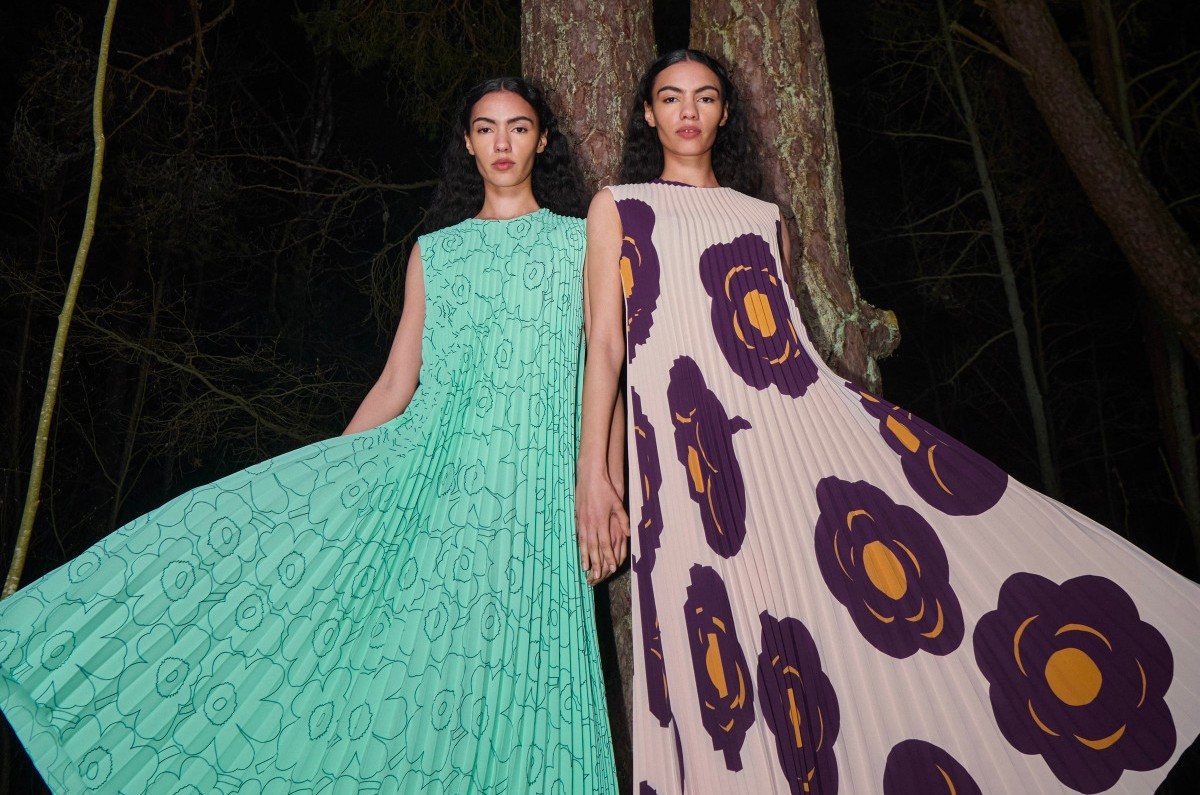 Two models wearing pleated dresses