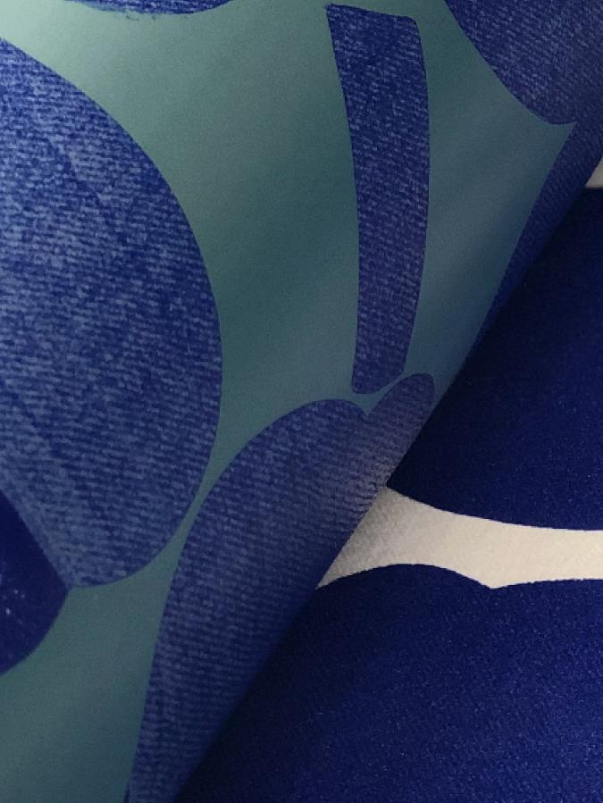 Printing machine printing blue and white Unikko pattern to fabric