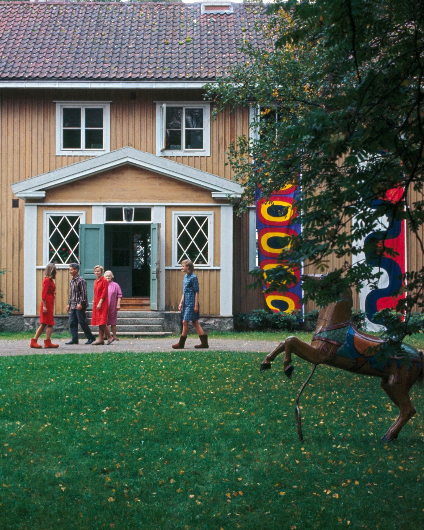 Photo by Tony Vaccaro of a house and people wearing Marimekko clothing.