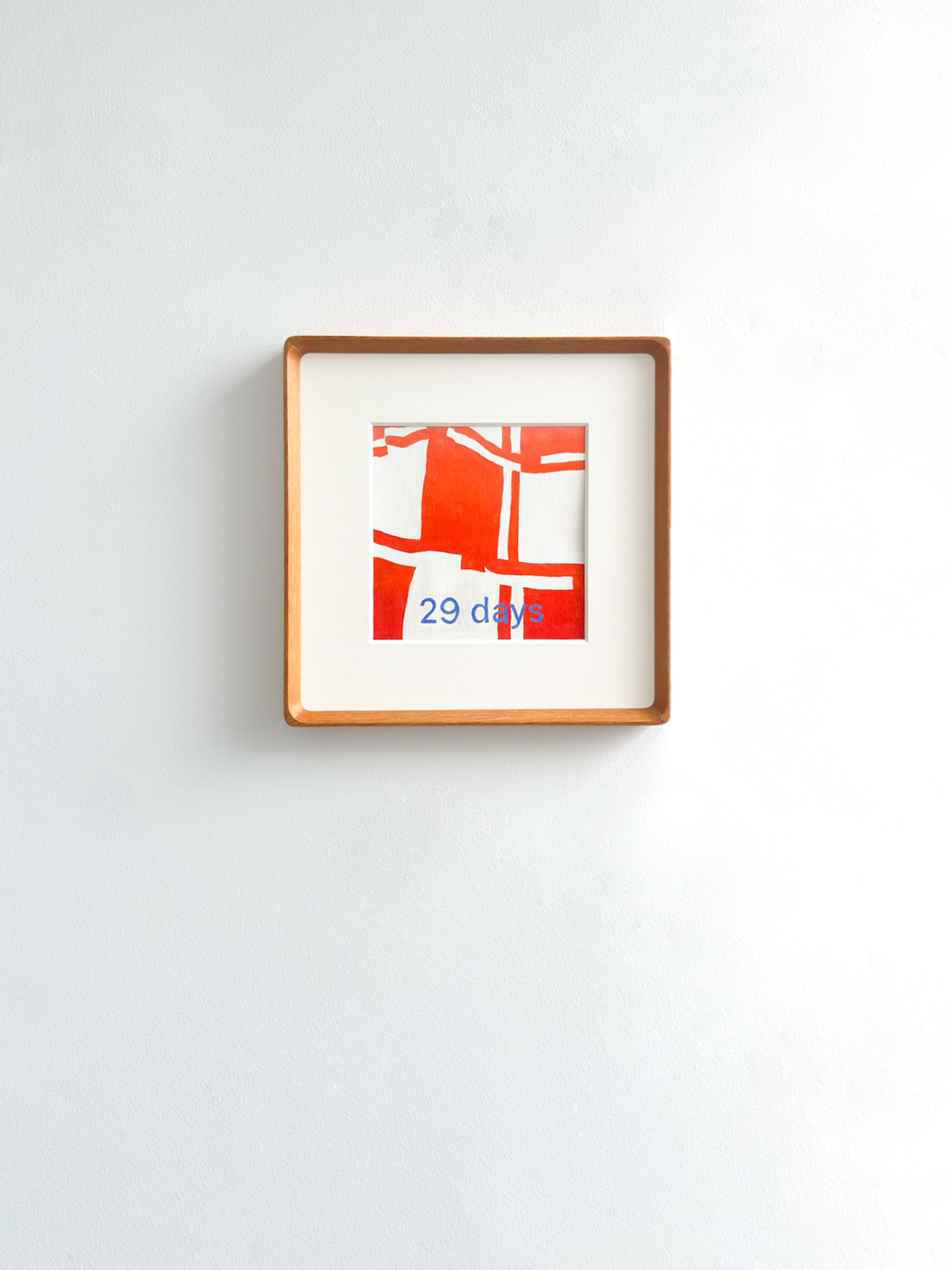29 days - a six by six framed geometric painting with red and white quilt pattern and "29 days" overlayed in blue paint