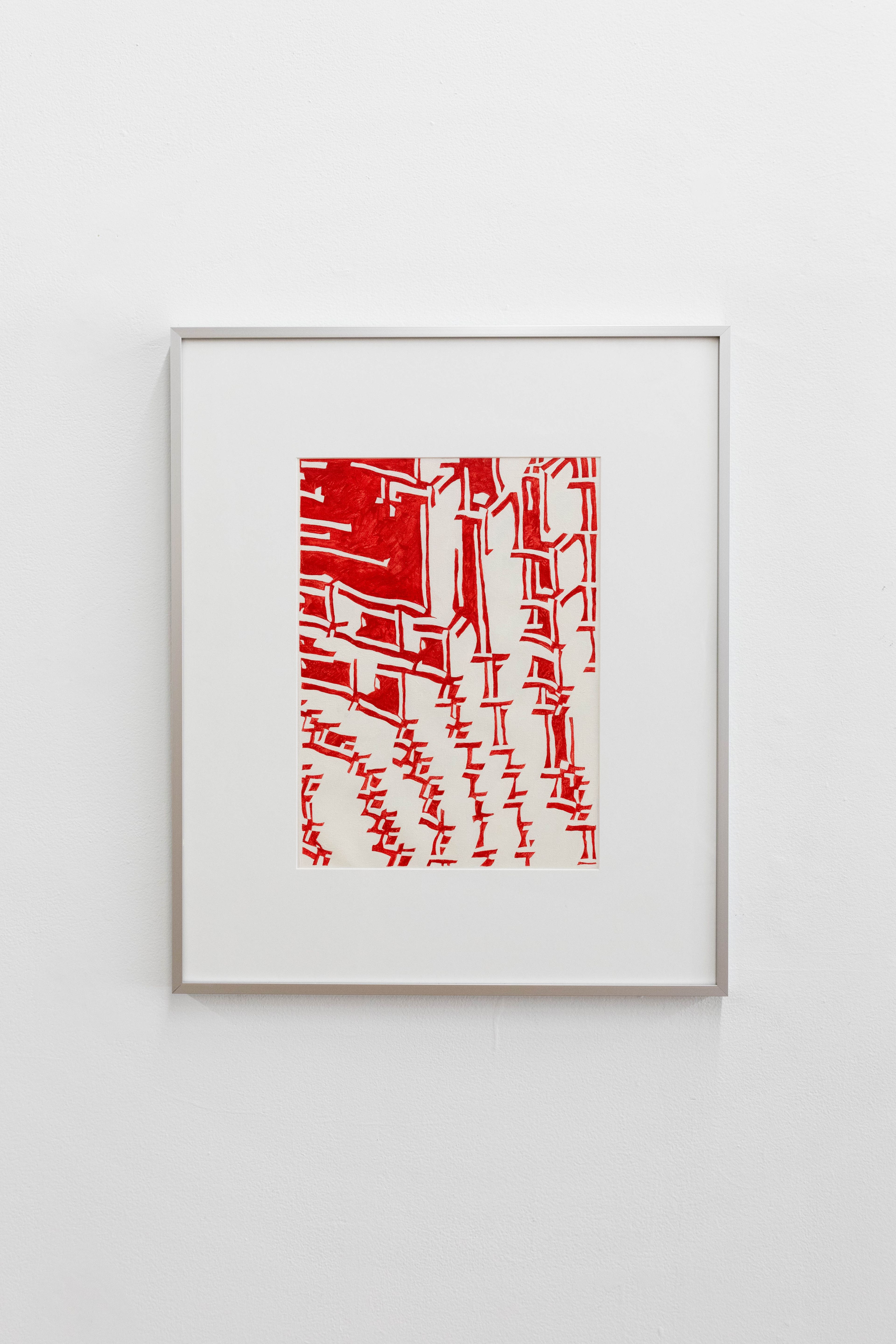 A framed abstract artwork with red geometric lines and shapes on a white background, displayed on a white wall.