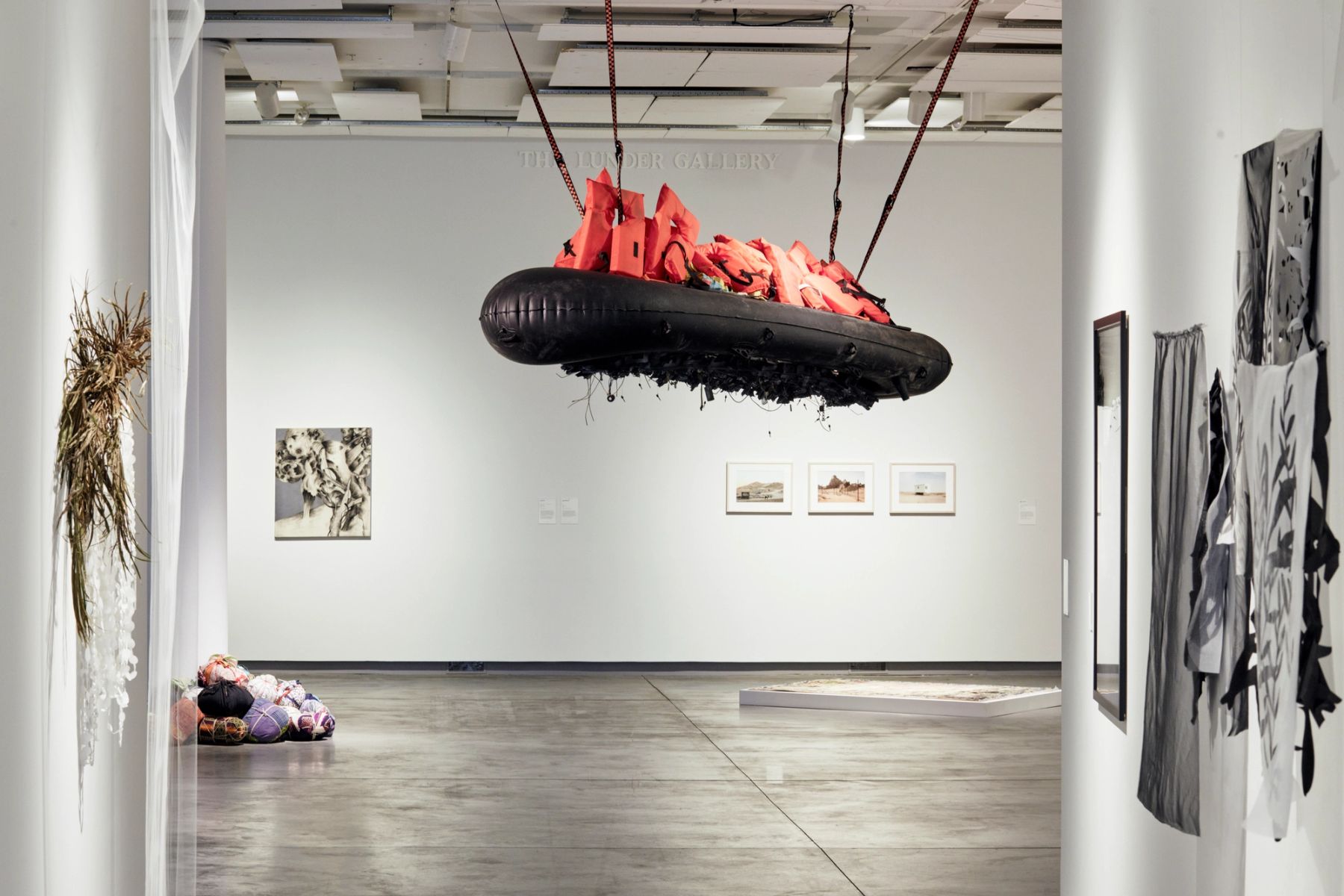Making Migration Visible: Traces, Tracks & Pathways installation view with works (left to right) by Edwige Charlot, Yu-Wen Wu, Ahmed Alsoudani, Mohamad Hafez, Eric Gottesman, Ranu Mukherjee, and Romuald Hazoumè.