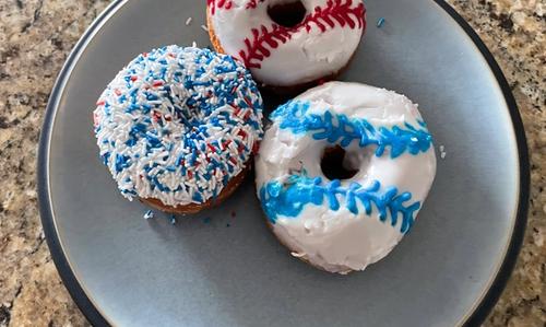 Three donuts decorated like baseballs.