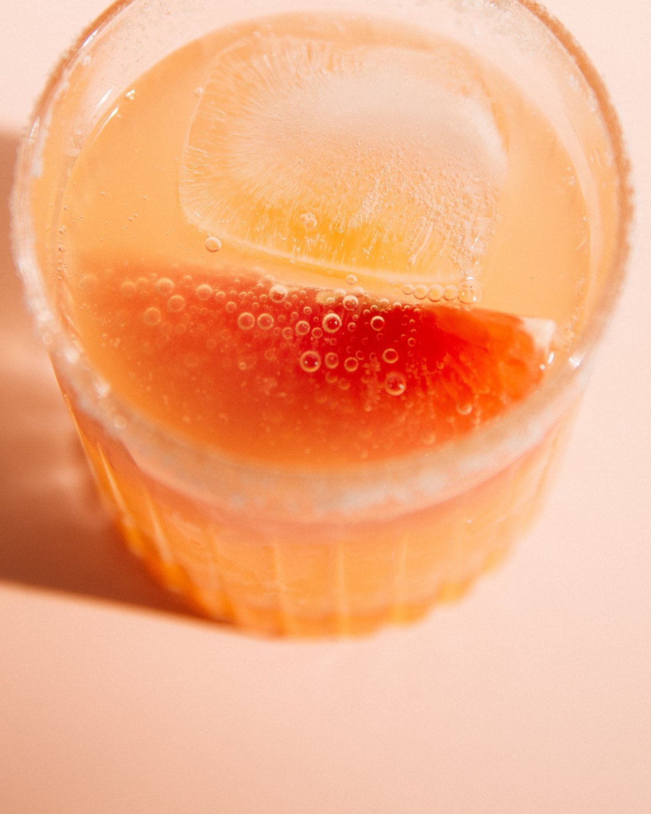 Close up of the Field Trip Paloma highlighting the bright grapefruit slice and bubbles from the club soda.