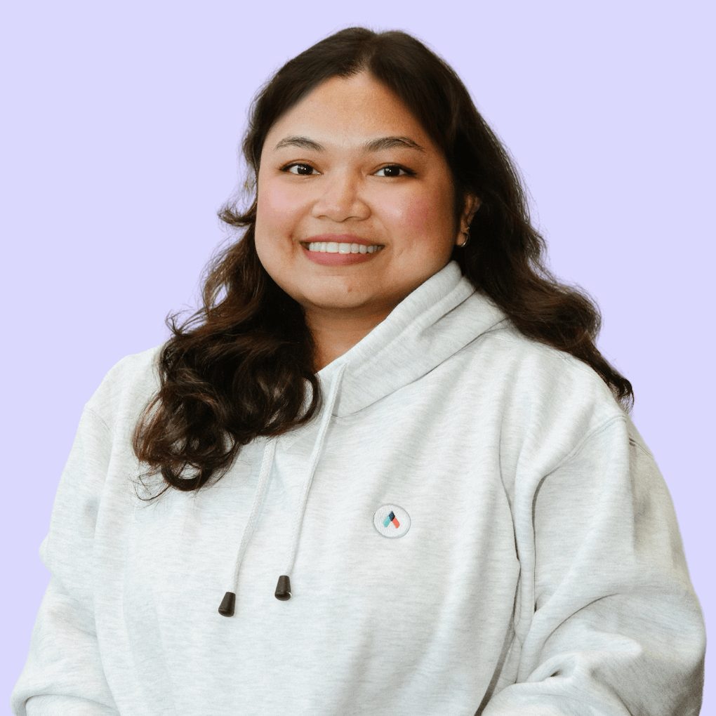 a woman wearing a white hoodie with a circle on it