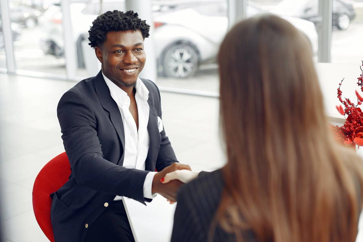 sales person handshakes their customer