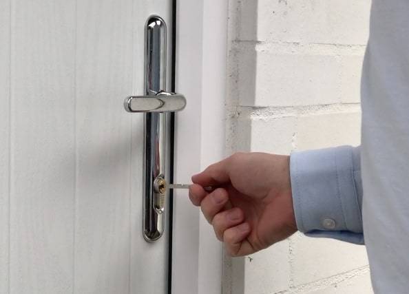 a man is opening a door with a key .