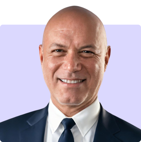 a bald man in a suit and tie smiles for the camera