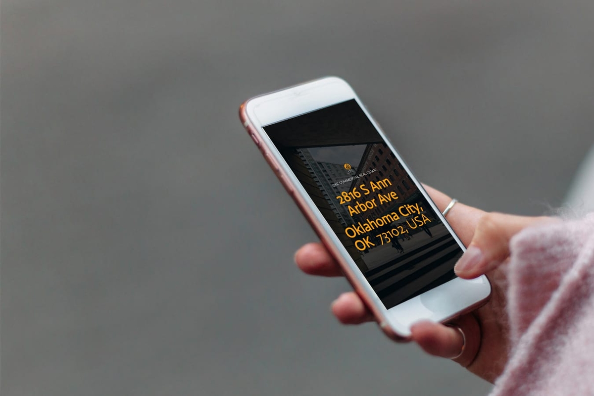 a person is holding a cell phone in their hand with real estate proposal on screen