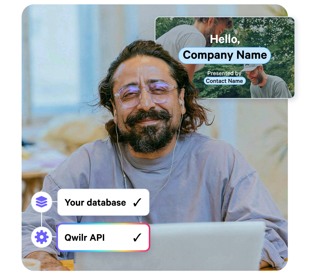 A smiling man with a beard and glasses looks at a laptop, flanked by a floating video window showing "Hello, Company Name" and labels for "Your database" and "Qwilr API" integration.