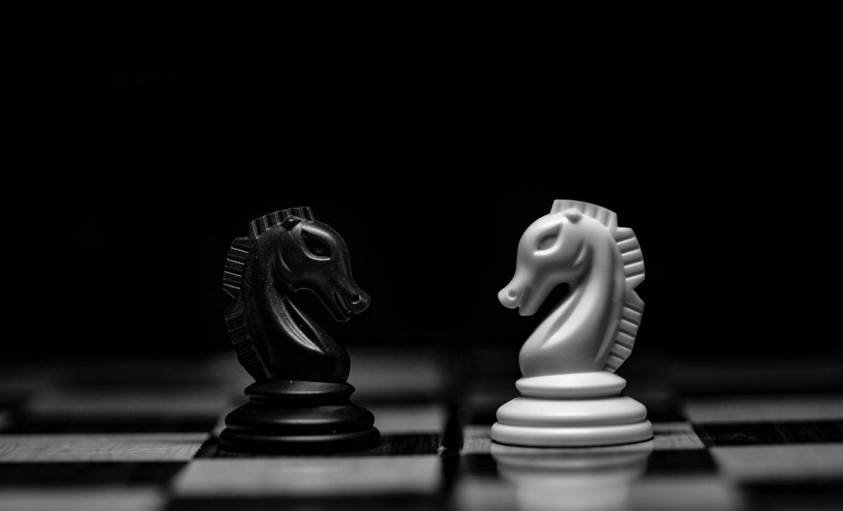 two chess pieces on a chess board