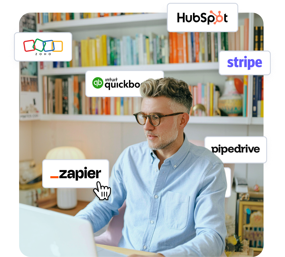 Man at laptop surrounded by various business software logos, with a cursor pointing to Zapier.